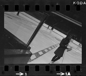 Reporter on ice rink at Boston Garden during workout by Peggy Fleming