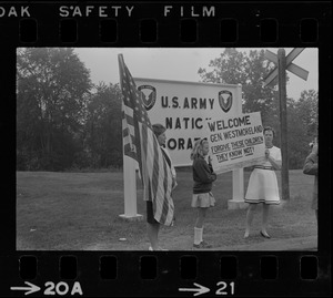 Two sides of Vietnam thinking - Mrs. Grace King and her daughter, Carolyn Sherbon, strong supporters of the government's Vietnam policy, carry sign welcoming Army Chief of Staff Gen. William Westmoreland to the Natick U.S. Laboratories