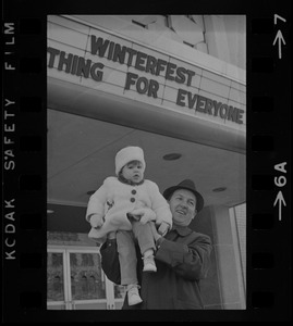 Man holding child outside Winterfest