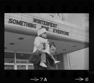 Man holding child outside Winterfest