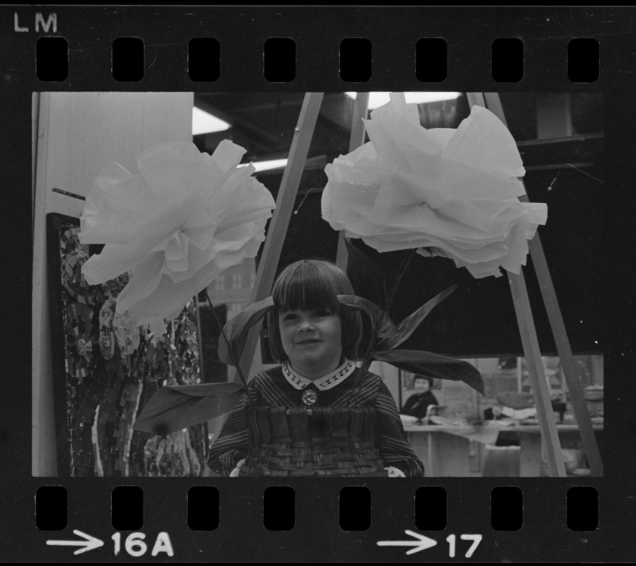 Girl posing with flower display at Winterfest