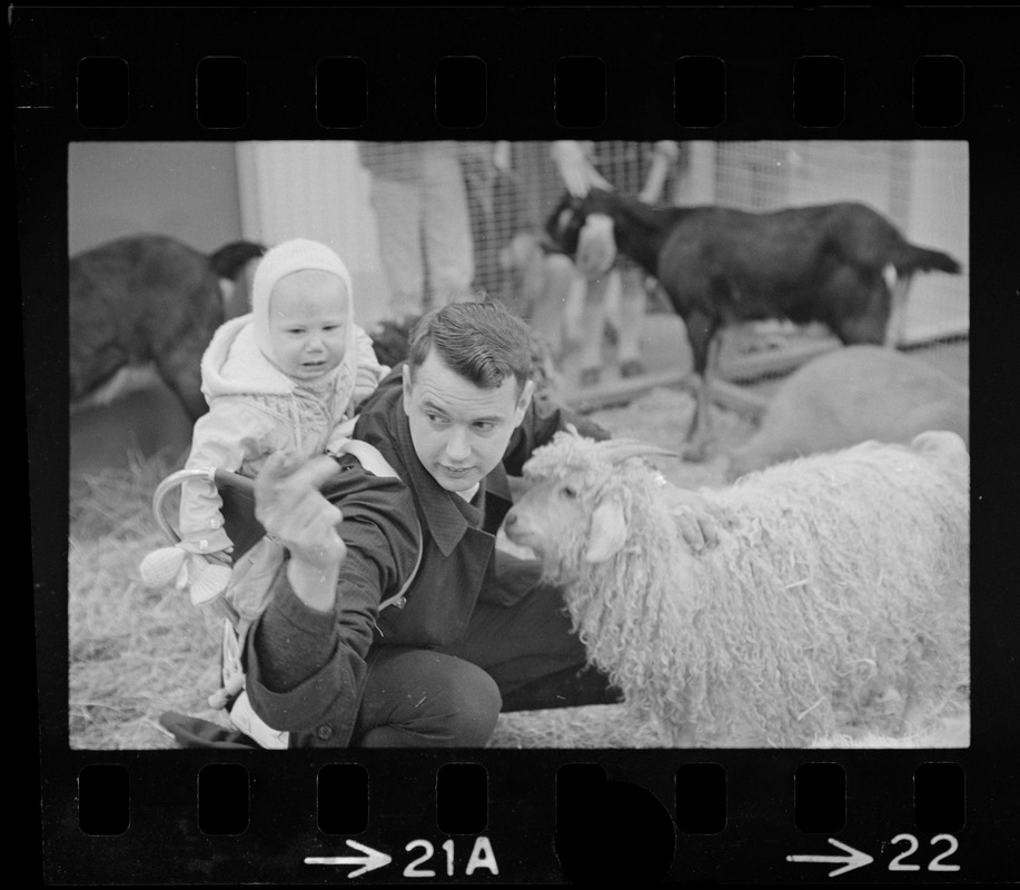 Man with child petting goat at Winterfest