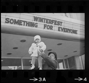 Man holding child outside Winterfest