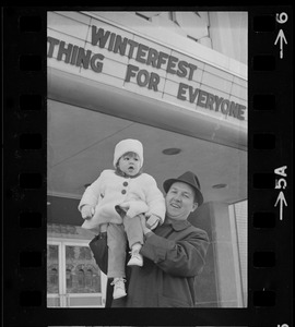 Man holding child outside Winterfest
