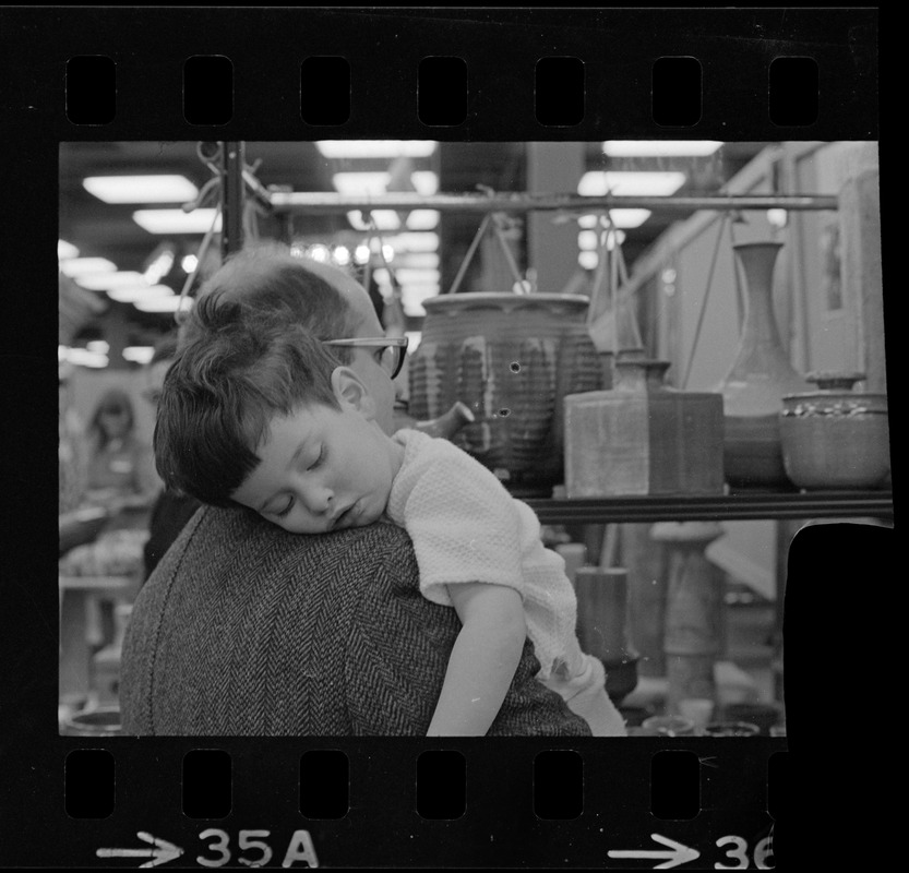 Child asleep on man's shoulder at Winterfest