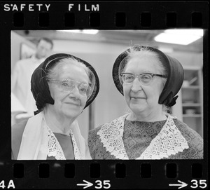 Two older women in bonnets at Winterfest