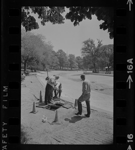 Workers at open Boston Water Works manhole in Boston Common