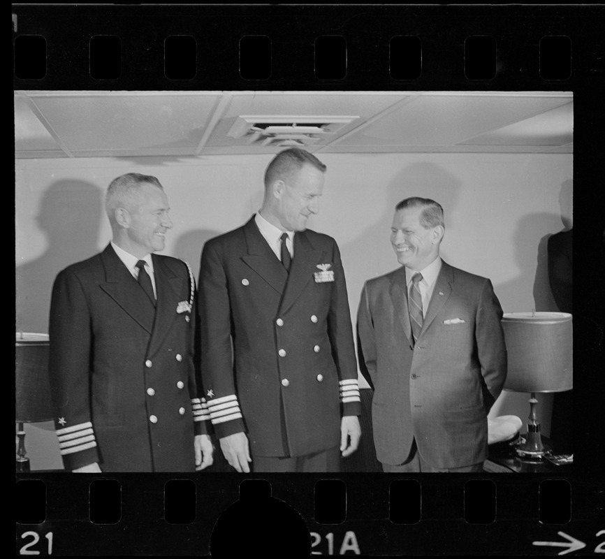 Two unidentified men, one possibly Capt. Gordon H. Hartley, and ...