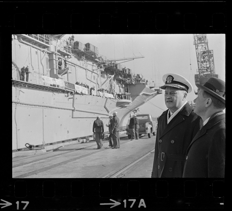 Governor John Volpe and Rear Adm. William B. Sieglaff watch the aircraft carrier Wasp arrive in port at South Boston after picking up Gemini astronauts