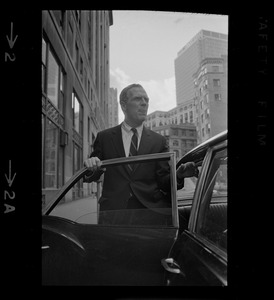 Mayoralty candidate Kevin White at back door of a car next to the Boston Insurance Exchange building