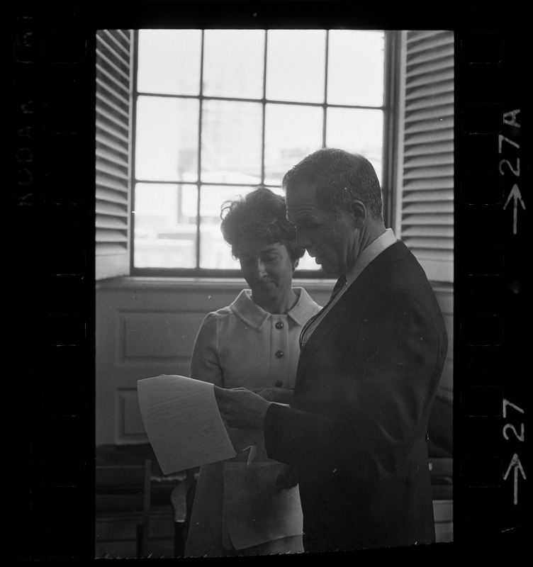 Boston Mayor Kevin White examining papers with unidentified woman at his inauguration