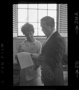 Boston Mayor Kevin White examining papers with unidentified woman at his inauguration