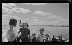 Group of five women and children on a boat