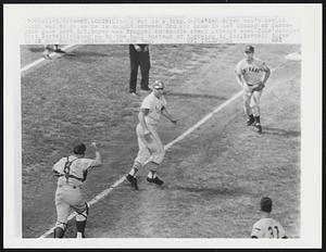 Like a rat in a trap, Cards' Ken Boyer can't decide which way to go as he is caught between 3rd and home in 1st inning of Cards-Cubs game here 8/5. Boyer was trapped on double steal attempt when Cubs' catcher Dick Bertell (6) hung on to the ball instead of throwing to 2nd. Bertell threw to 3B Ron Santo (top) who made the tag.