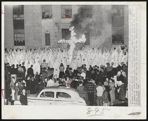 Klan Burns Cross in Georgia-Ku Klux Klansmen burned a cross before the Emanuel County Courthouse here last night as a crowd of spectators look on. They paraded in full regalia for the first time since the hey day of the Klan in the Twenties.