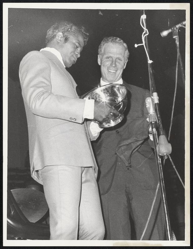 Mayor White presents Paul Revere Bowl to entertainer James Brown at Boston Arena last night in appreciation for Brown's effort to cool things in city during aftermath of Martin Luther King's death.