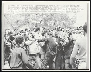 Demonstrators attack Chicago Police Capt. Paul McLaughlin, (L) and an unidentified Sgt. (C) during clash outside the Federal Building 9/24, where eight persons are on trial for conspiring to promote riots during the 1968 Democratic National Convention. At least 13 demonstrators were arrested and five persons, including two policemen, were injured during the brief melee.