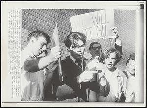 Burns Draft Card in Protest- A youth identified as Dennis Diordan burns his draft card in from of an induction center on Chicago's Van Buren St., today as another draft-protester, right, shouts at the photographer. Moments later, a group of draftees reporting to the center, attacked the pickets who were mauled.