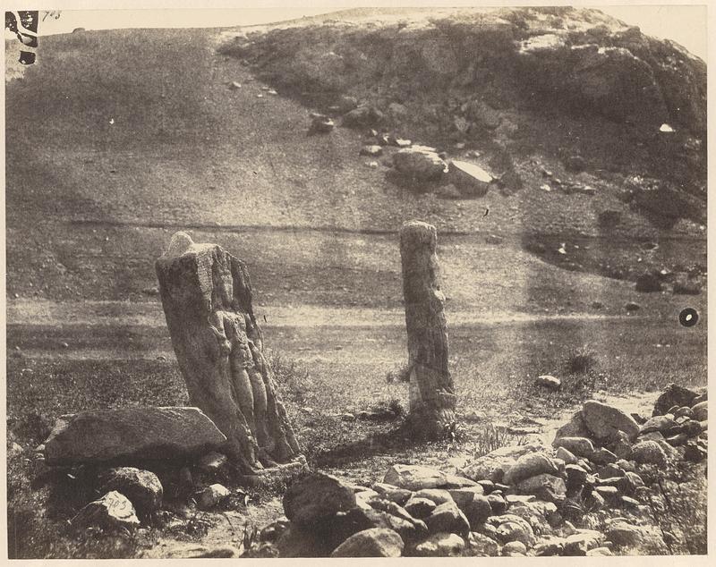 Two carved stela at the base of a hill