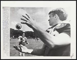 The Old Pitch- Catch Combination--As College All stars assemble today, a well-known college passing combination--Terry Hanratty (5) to end Jim Seymour--warms up at Evanston. Their playing days at old Notre Dame over, they're figuring on starting against New York jets Aug. 1 at Chicago.