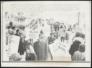 Teachers Strike at S.F. State--Striking teachers, students and sympathizers man a picket line on the sidewalk at the main entrance to San Francisco State College as it opened today after a three-weeks holiday vacation. Third from left behind sign : "Faculty-Student Unity Will Win!" is Dr. Carlton Goodlett, Negro community leader. State faculty members aligned with the American Federation of Teachers officially struck today in support of the striking students and demanding economic improvements.