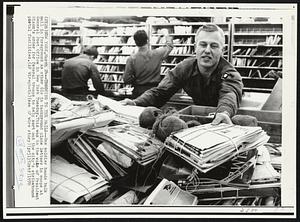 Trooping to the Mails--One soldier hands bulk mail in foreground as other GIs in background place letters in coops at General Post Office in New York Tuesday. This was in the wake of President Nixon's order for federal troops to help sort out the city's strikebound postal facilities.
