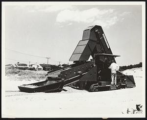 Real Beachcomber is this Barber-Greene monster apparatus bought by the town Barnstable on Cape Cod to crawl across the beach, sifting and for shells, tin cans, bottle caps, broken toys and glass, engagement and wedding rings, and money.