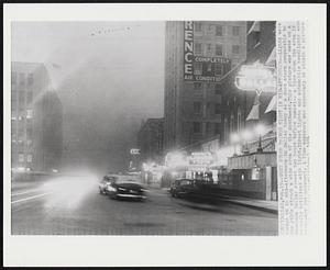 Dust Storm Brings Night in Mid-Afternoon--Lights were turned on by mid-afternoon in Dallas today as a dust storm comparable to the 1930s struck a wide area of the Southwest. This picture was made on a downtown Dallas street two hours before sunset-- a time when the area is normally brilliant with light. Street lights and automobile headlights were necessary for movement. A time exposure was necessary to obtain a picture.