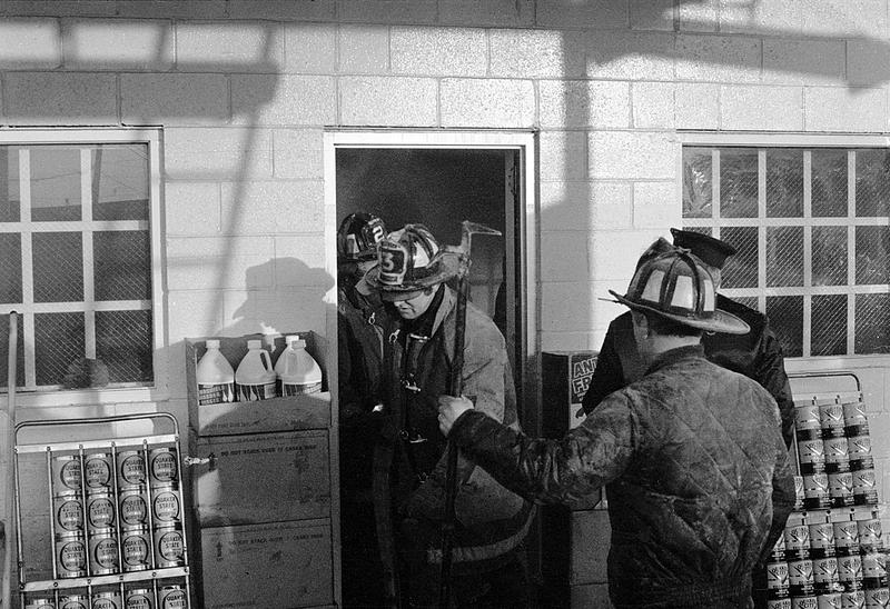 Chelsea firefighters Robbie Ostler and Roy Butt standing outside as firefighter Joe Siewko and E3 Lt. exit the building