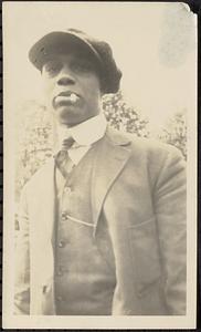 Man in cap smoking cigarette