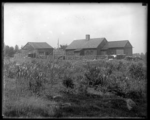 Unidentified house with a large woodpile in front