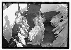 Women hanging laundry on clotheslines