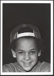 Child smiling with baseball hat