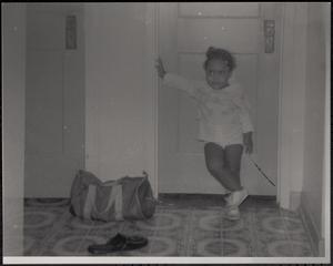 Little girl posing in front of door