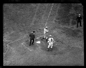 Player crosses home plate as Boston Braves catcher looks on