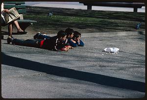 Three boys lying on their stomachs on path, Boston Common