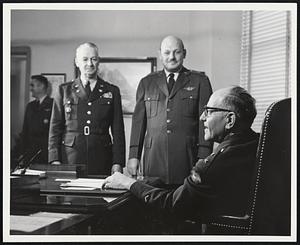 “Operation Minuteman,” the nationwide test alert of the Army and Air National Guard was touched off by Major General Edgar C. Erickson, chief of the National Guard Bureau, who is shown here advising the chiefs of The Army and Air Force Divisions of the Bureau, (Major General William H. Abendroth, U.S. Army, and Brigadier General Winston P. Wilson, U.S. Air Force) that word has been flashed to the States and territories alerting more than 350,000 members of Army and Air National Guard Units. More than 2400 communities were affected by the historical test alert in which over 5500 army and air units of The National Guard participated. Washington, D.C. 20 April 1955. Official U.S. Army photo released by Dept. of Defense.