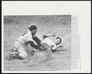 Tiger Run Nipped at the Plate--Third baseman Bubba Phillips, of the Detroit Tigers, tagged at home plate by New York Yankees catcher Elston Howard in night contest today. Phillips ran from second when pitcher Hank Aguirre rammed a bases-loaded single to center in 5th inning. New York outfielder Mickey Mantle made a perfect peg to the plate to nip Phillips and the Detroit rally.