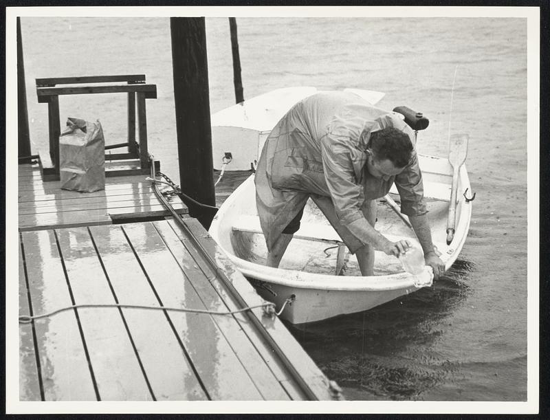 Douglas Cushman of Holden bails out boat. Bourne, Cape Cod