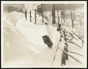 A Four-Man Thrill on a Zig-Zag Curve The Zig-Zag Curve on the Bob-Sled Run at Mt. Van Hoevenberg, Lake Placid, N. Y., Provided Plenty of Thrills for Spectator Feb. 13 as the Various Entries Fought for the Right to Represent U. S. in the Coming Olympics. The Team Shown Above on the Curve was Captained by Aubrey Wells, and Contained Kurt Gelback, Clark N. Defendorf, and Roy Tallman (Brake), All of the Keene Valley, N. Y. Athletic Association.