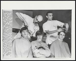 Not Enough Off the Top -- Three teen-age rock 'n roll singers who lost their federal case with a principal over their long tresses get a trim by barbers at the night spot in Dallas where they are appearing. Phillip Farrell, left, gets trimmed by Bill Nunn while Paul Jarvis, right, is clipped by Roscoe Nunn of the father and son tonsorial team. Steve Webb, the third mop-top, waits his turn. When the barbers were through there was hardly enough hair shorn to make a painter's brush. Certainly not enough to satisfy the high school officials.