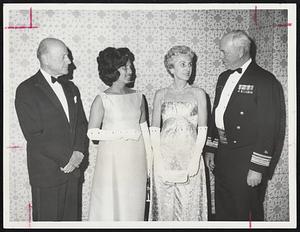 Charles F. Adams, Chairman of board Raytheon Corp., and guest of honor at the fourth annual Constitution Ball, Converses at Statler Hilton with Rear Admiral Joseph C. Wylie, USN, Commandant, First Naval District, Mrs. Wylie and Mrs. J Richard Lamere, second left, of Duxbury. More than 1,000 Naval officers, wives, dignitaries and civilian friends attend social event benefitting the Naval Relief Society.