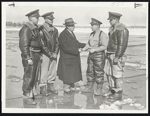 Lt. Louis C. Adams of the army air corps (second from right) being greeted at the airport yesterday by his father Lt. Louis Adams of the Ancient & Honorable Artillery Company. The son with his flight companions, (left to right) Lt. Columbus Savage, Lt. Melvin R. Swenson and Lt. H.R. Roth flew an army bomber to Boston from Savannah, Ga., yesterday. Lt. Adams, a graduate of Brown University, lives at 227 Waltham Street, West Newton and is a member of the 16th light bombardment squadron.