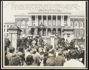 Demonstrators protesting Gov. Sargent's tighter welfare controls, parade in front of the State House 4/5 with police blocking the entrance to the executive building. Minutes later the protestors broke ranks and tried to gain entrance to the State House. Police arrest three.