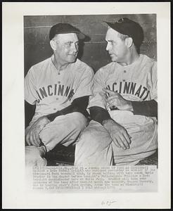 Sewell Winds up Term as Cincinnati Manager- Luke Sewell (right) who resigned yesterday as manager of the Cincinnati Reds baseball club, is shown talking with team coach Earle Brucker in the dugout before tonight's Philadelphia Phillies- Reds twinight doubleheader here at Shibe Park. Brucker will take over guidance of the team after tonight until new manager, Rogers Hornsby, who is touring club's farm system, joins the team at Cincinnati August 5.