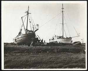 Fishing boat and yacht swept ashore at Menemsha on Martha's Vineyard by Wednesday's tidal waves.