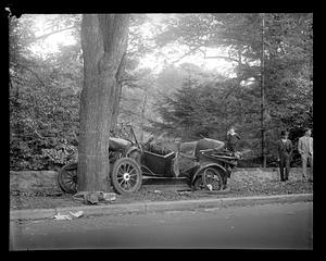 Wrecked car which has hit a tree