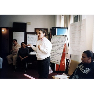 Meeting facilitator addresses community members at a meeting in the Inquilinos Boricuas en Acción offices.