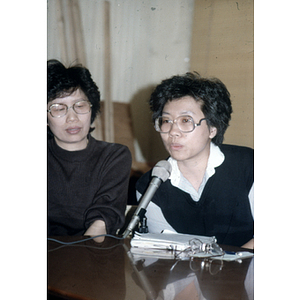 Suzanne Lee speaks from a microphone during an unidentified Chinese Progressive Association gathering