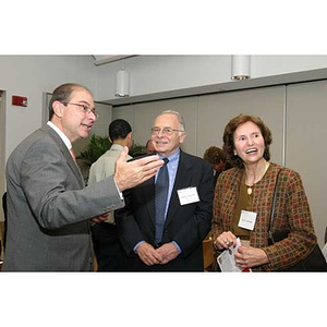 President Aoun gestures while conversing with Sam Altschuler at the Torch Scholars dinner